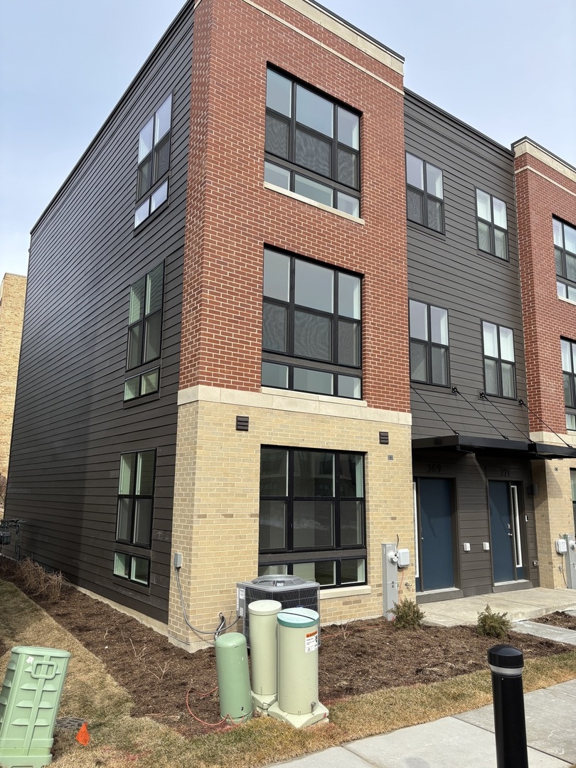 369 Summit Circle Lombard, IL 60148 - Photo 1 of 11 a front view of a building with a street