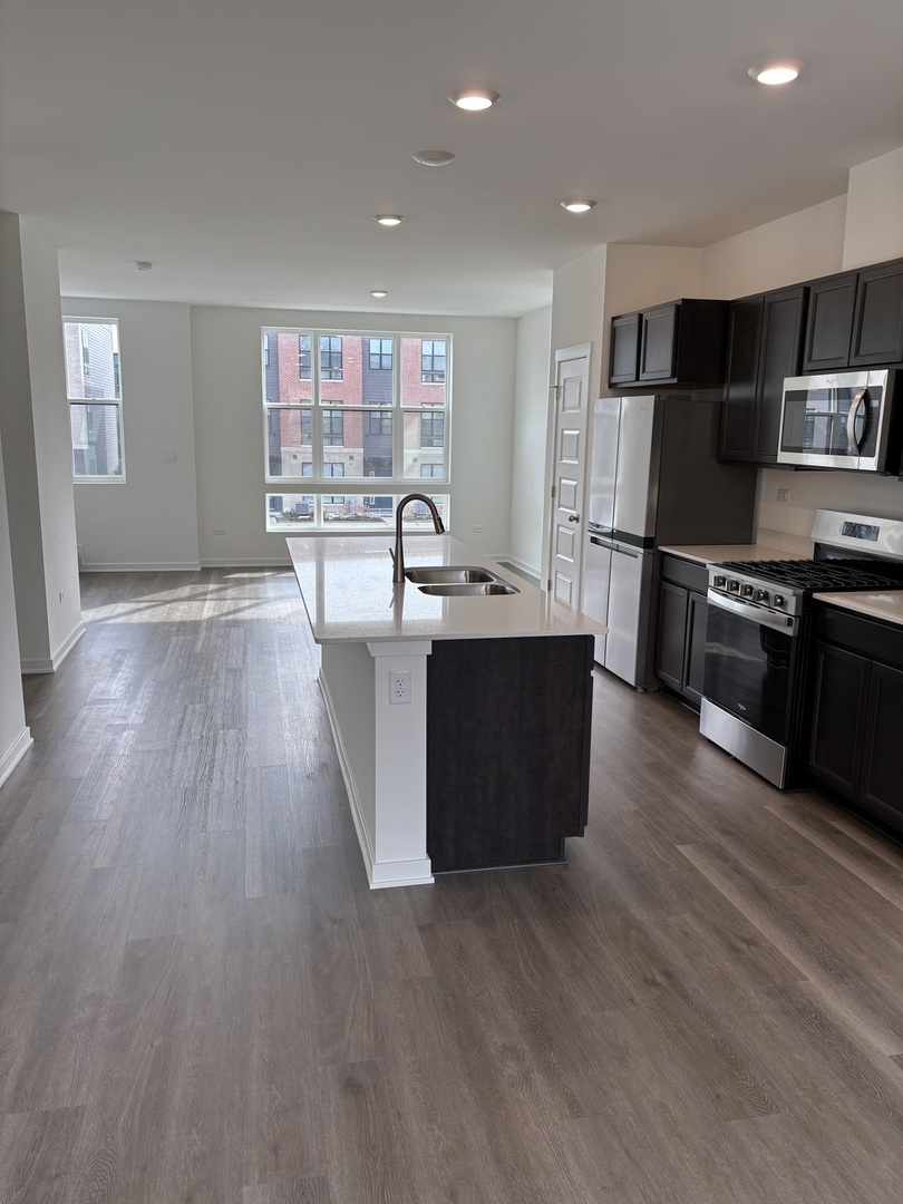369 Summit Circle Lombard, IL 60148 - Photo 2 of 11 a kitchen with stainless steel appliances wooden floors and wooden cabinets