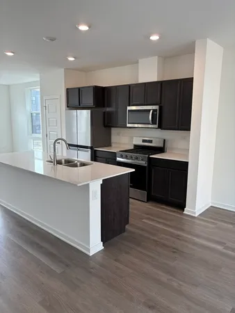 a kitchen with stainless steel appliances granite countertop a sink and stove top oven