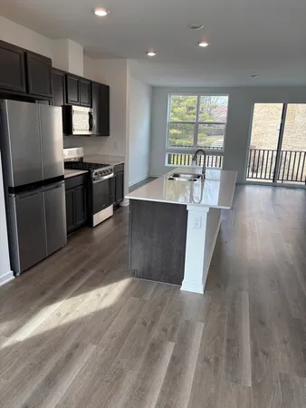 a kitchen with stainless steel appliances a refrigerator and a stove