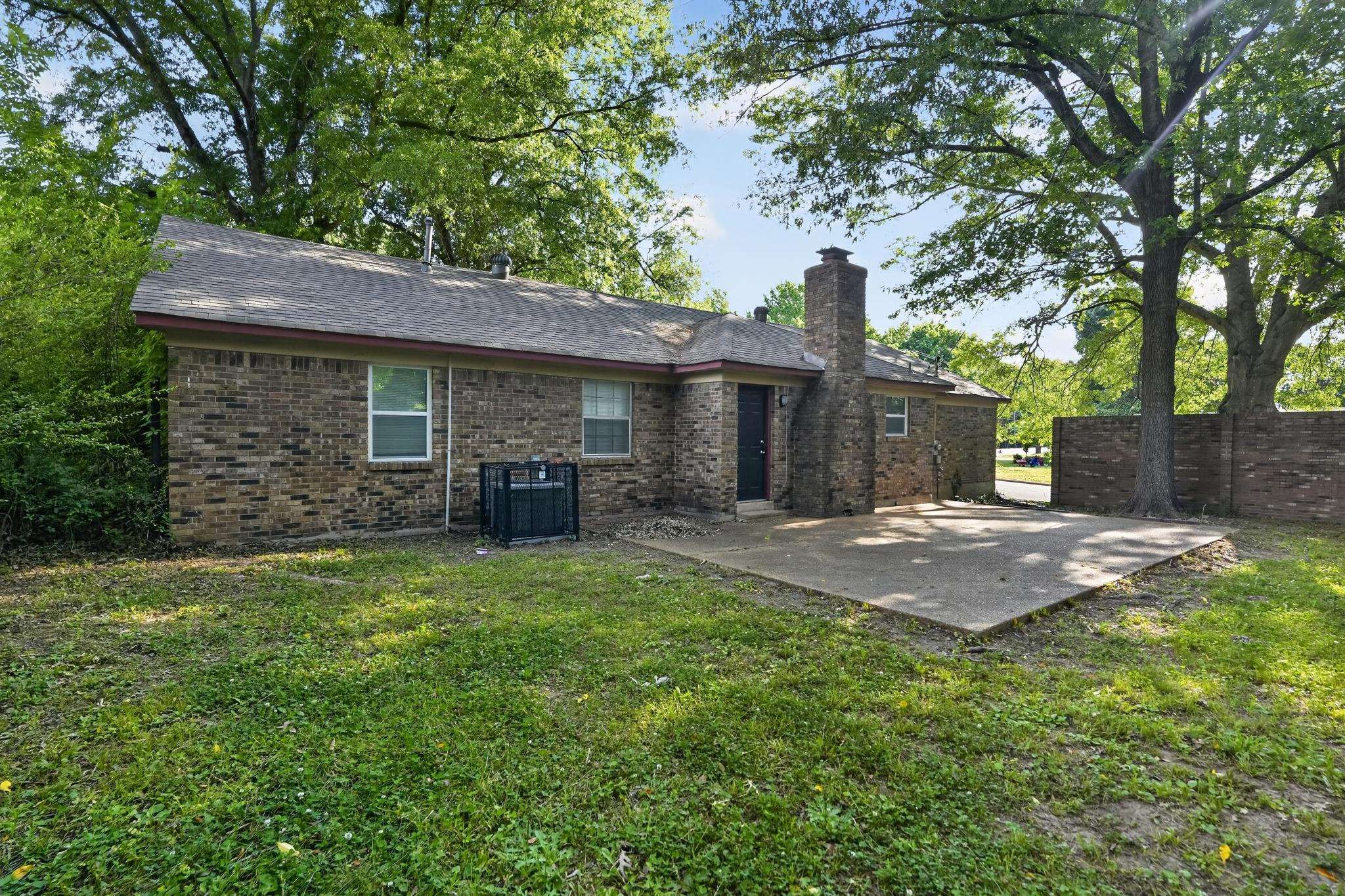 2015 East Holmes Road Memphis, TN 38116 - Photo 5 of 34 a front view of a house with a garden and trees