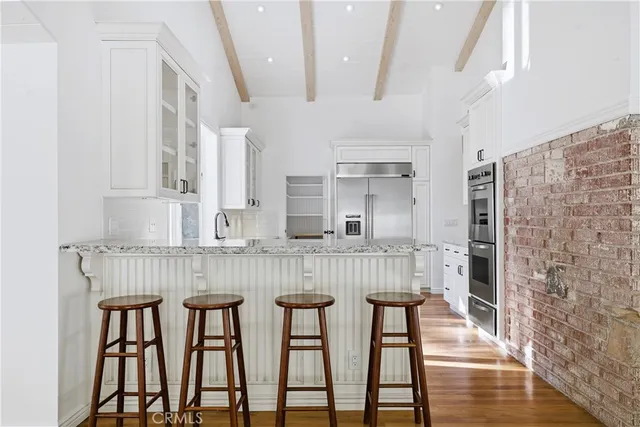 a kitchen with a sink stove and refrigerator