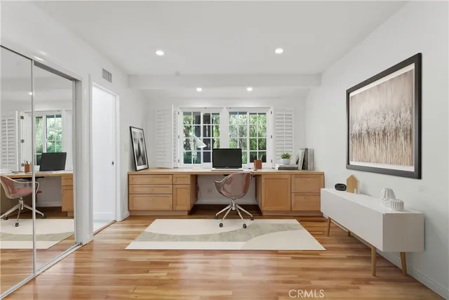 a bathroom with a granite countertop toilet a sink a mirror and a shower