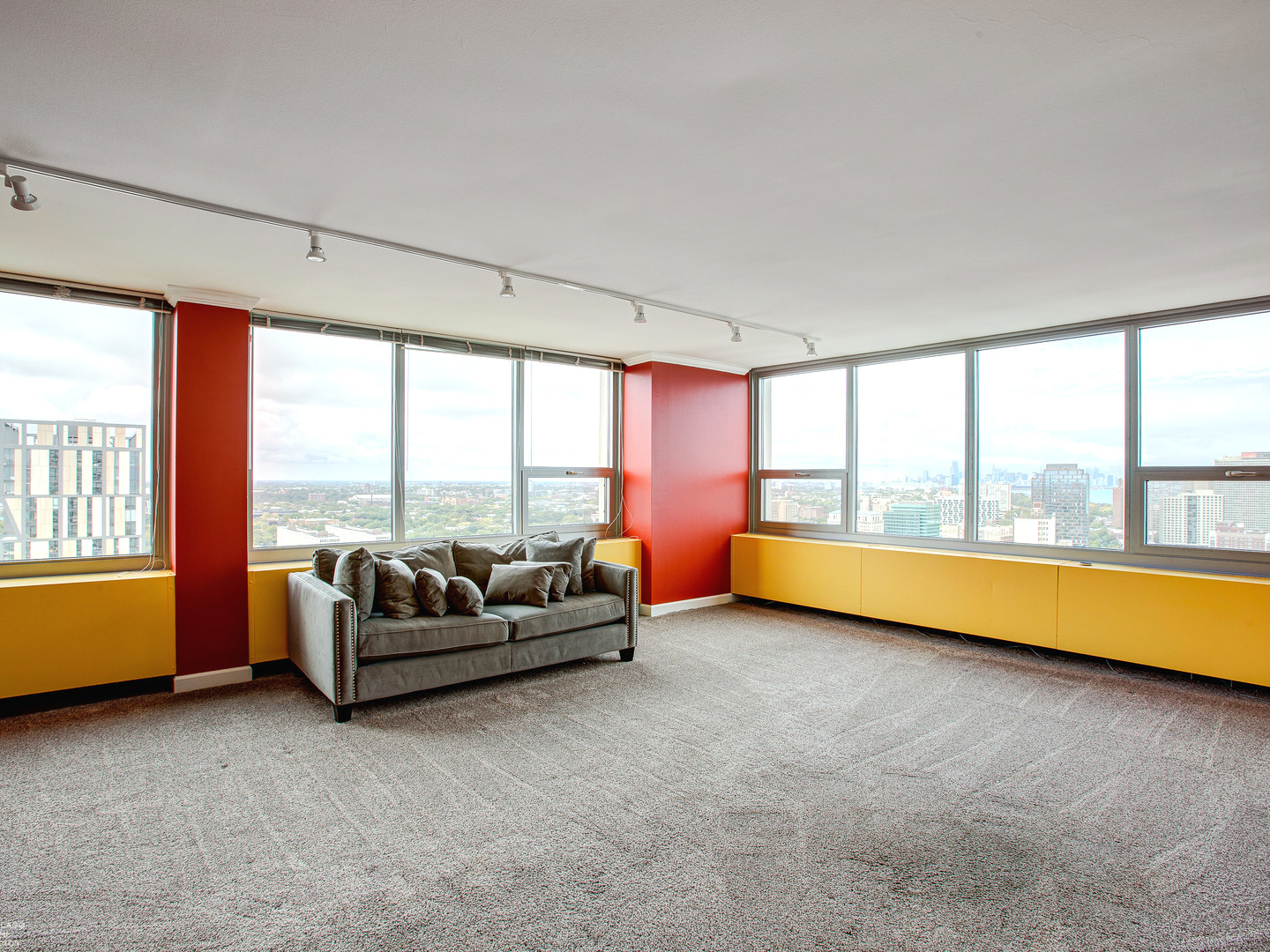 1700 East 56th Street, Unit 2907 Chicago, IL 60637 - Photo 4 of 17 a living room with furniture and large windows