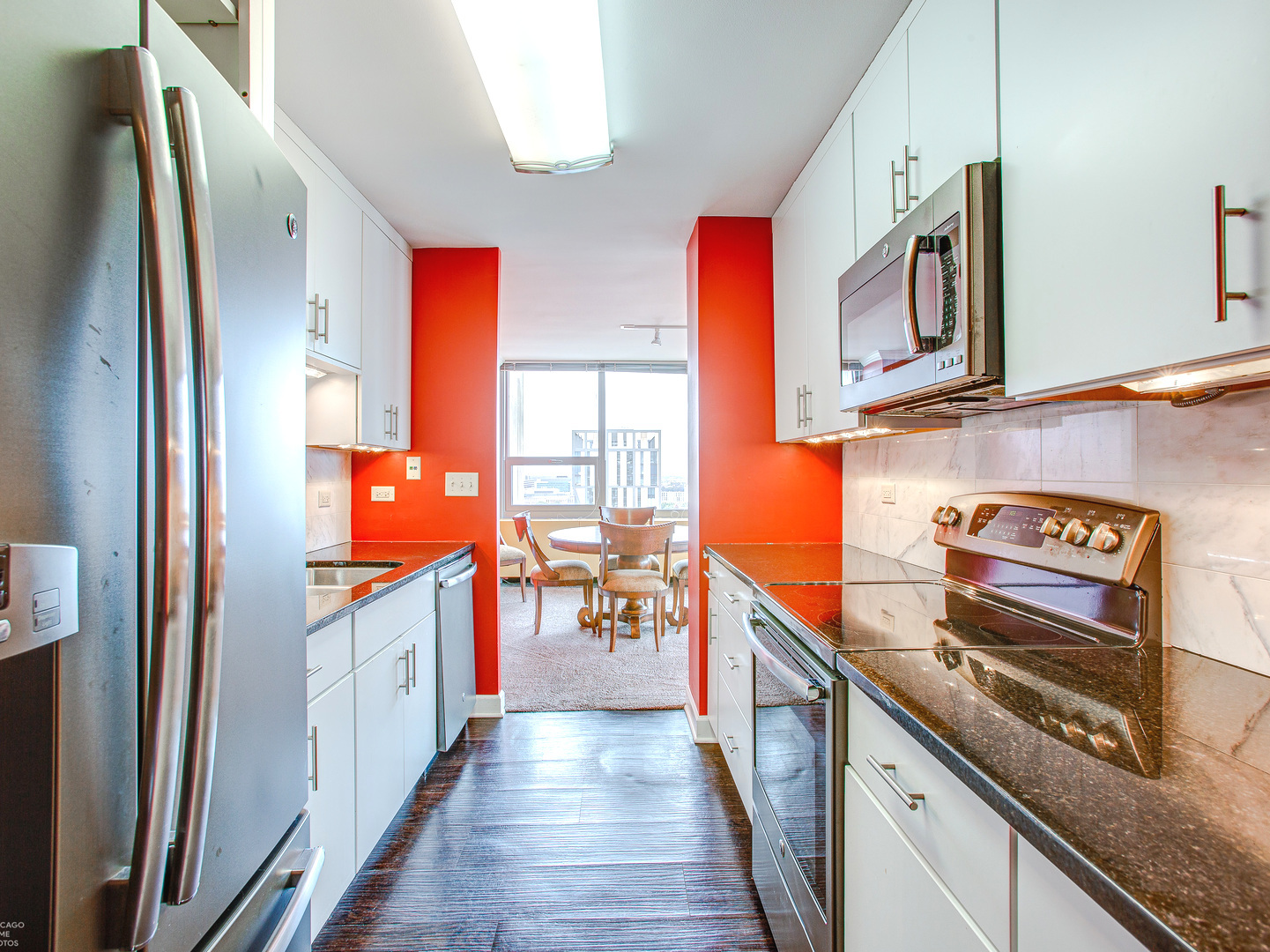 1700 East 56th Street, Unit 2907 Chicago, IL 60637 - Photo 9 of 17 a kitchen with stainless steel appliances granite countertop a stove and a refrigerator