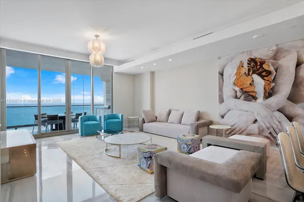 a living room with furniture and a chandelier
