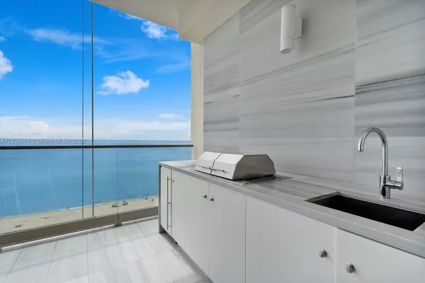 a kitchen with a sink and a refrigerator