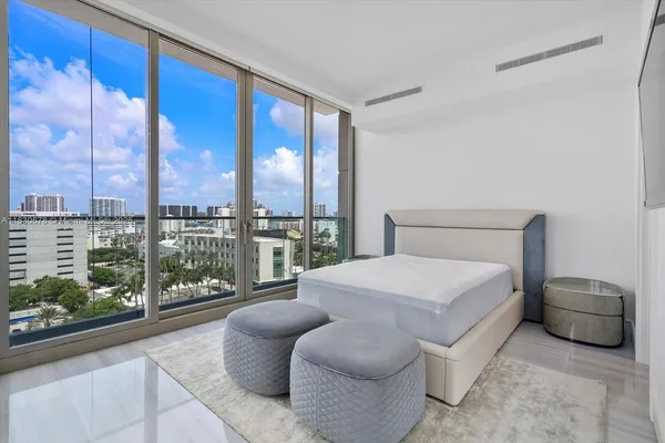 a bedroom with a large bed and a large window
