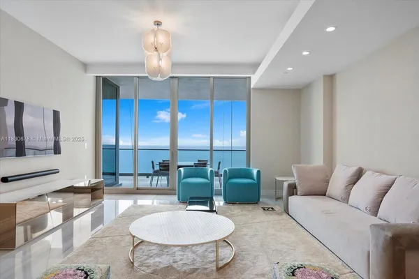a living room with furniture a chandelier and a chandelier