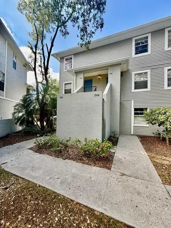 a front view of a house with a yard and a garage