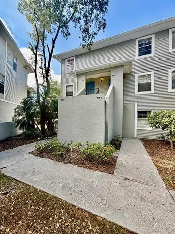 a front view of a house with a yard and a garage