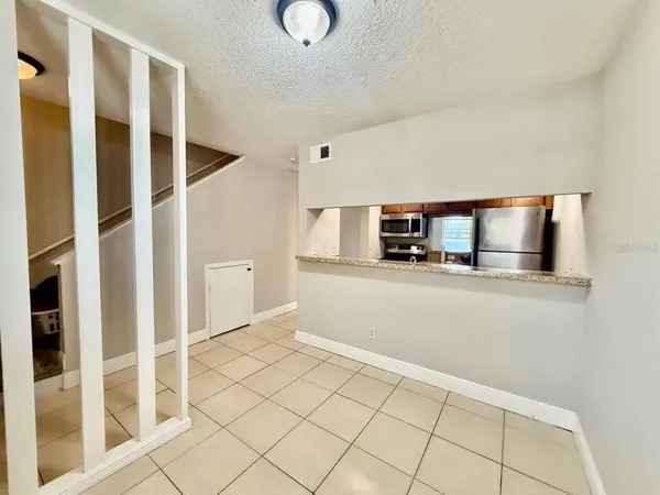 a view of empty room with wooden floor and cabinet