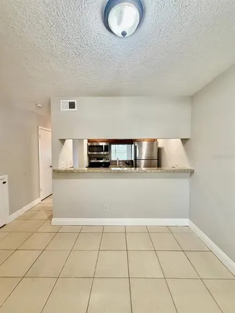 a view of kitchen with white cabinets