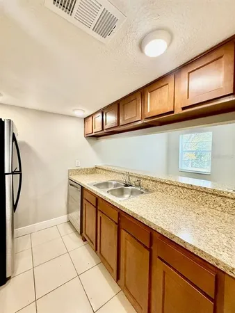 a kitchen with stainless steel appliances granite countertop a sink and cabinets