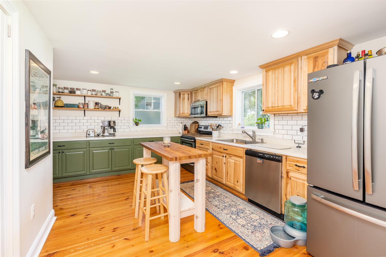 352 Battlefield Road Waynesboro, VA 22980 - Photo 9 of 46 a kitchen with stainless steel appliances granite countertop a refrigerator a sink dishwasher a stove with wooden cabinets and floor