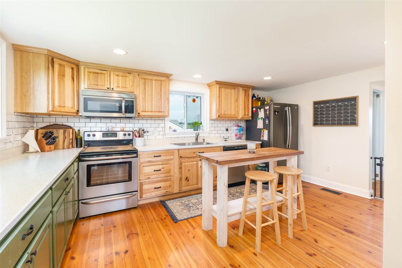 352 Battlefield Road Waynesboro, VA 22980 - Photo 10 of 46 a kitchen with stainless steel appliances granite countertop a stove a sink dishwasher and a refrigerator with wooden floor