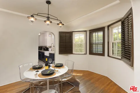 a view of a dining room with furniture and wooden floor