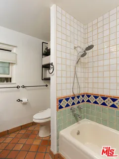 a bathroom with a bathtub and shower