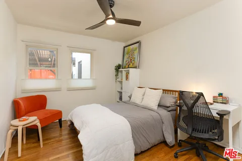 a bedroom with a bed and a desk