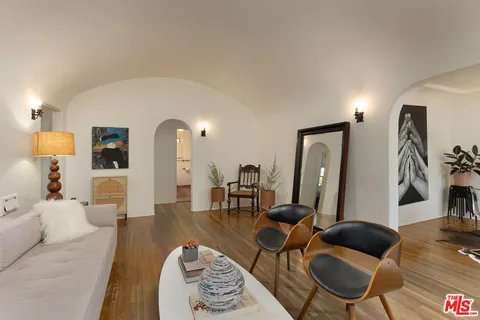 a living room with furniture and wooden floor