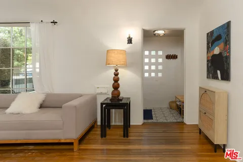 a living room with furniture and a wooden floor