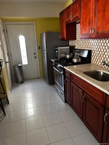 a view of a room with wooden floor and a window
