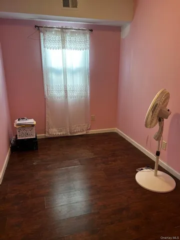 a bed sitting in a bedroom next to a larger window