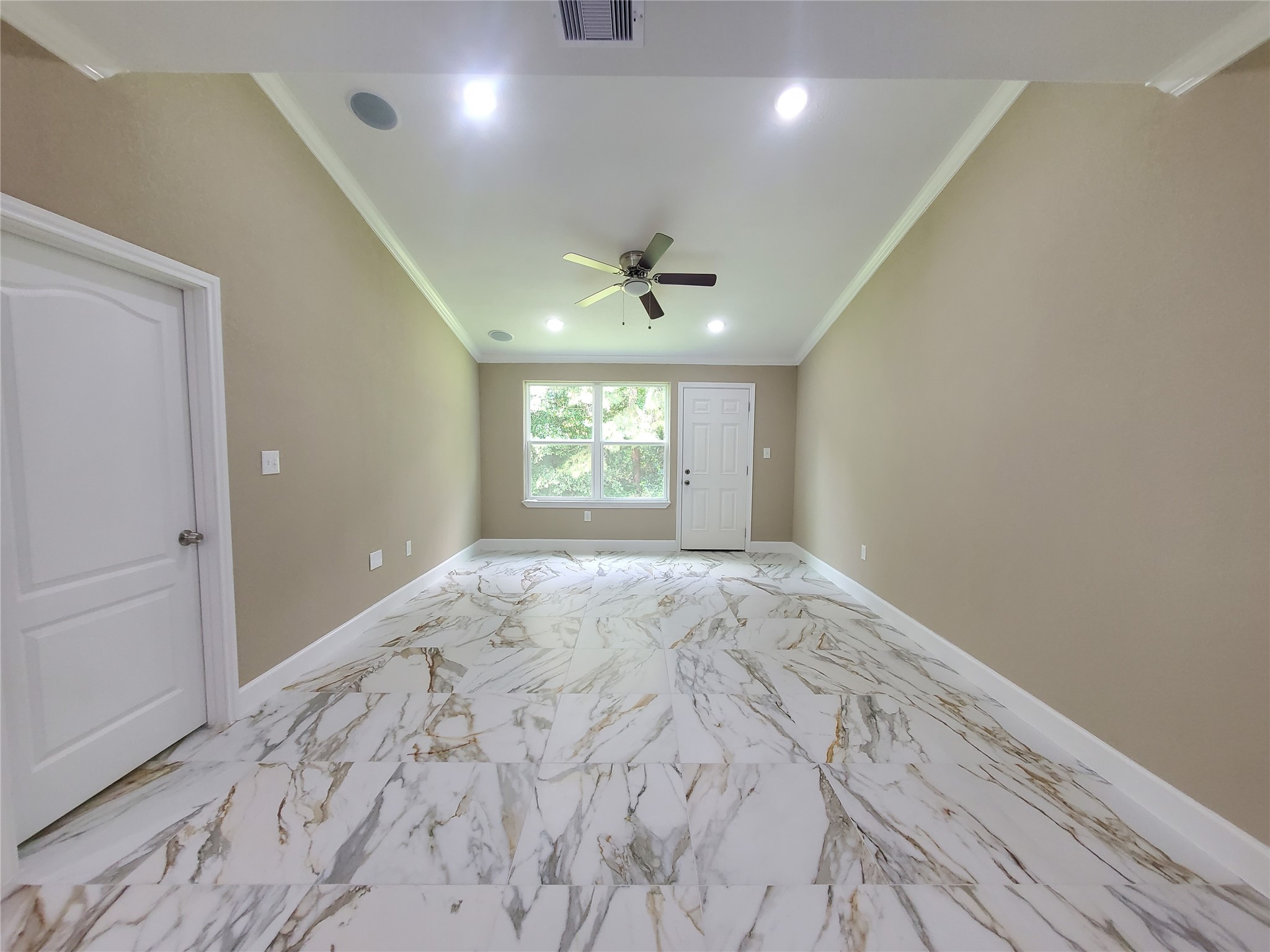 1306 North 9th Street Conroe, TX 77301 - Photo 9 of 47 an empty room with windows and ceiling fan