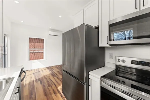 a kitchen with stainless steel appliances granite countertop a refrigerator and a stove top oven