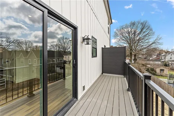 a view of a balcony with wooden floor and iron stairs
