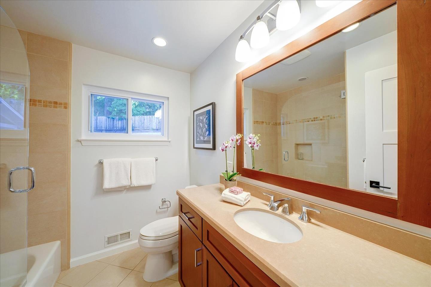 1122 Southdown Road Hillsborough, CA 94010 - Photo 16 of 42 a bathroom with a toilet sink and mirror