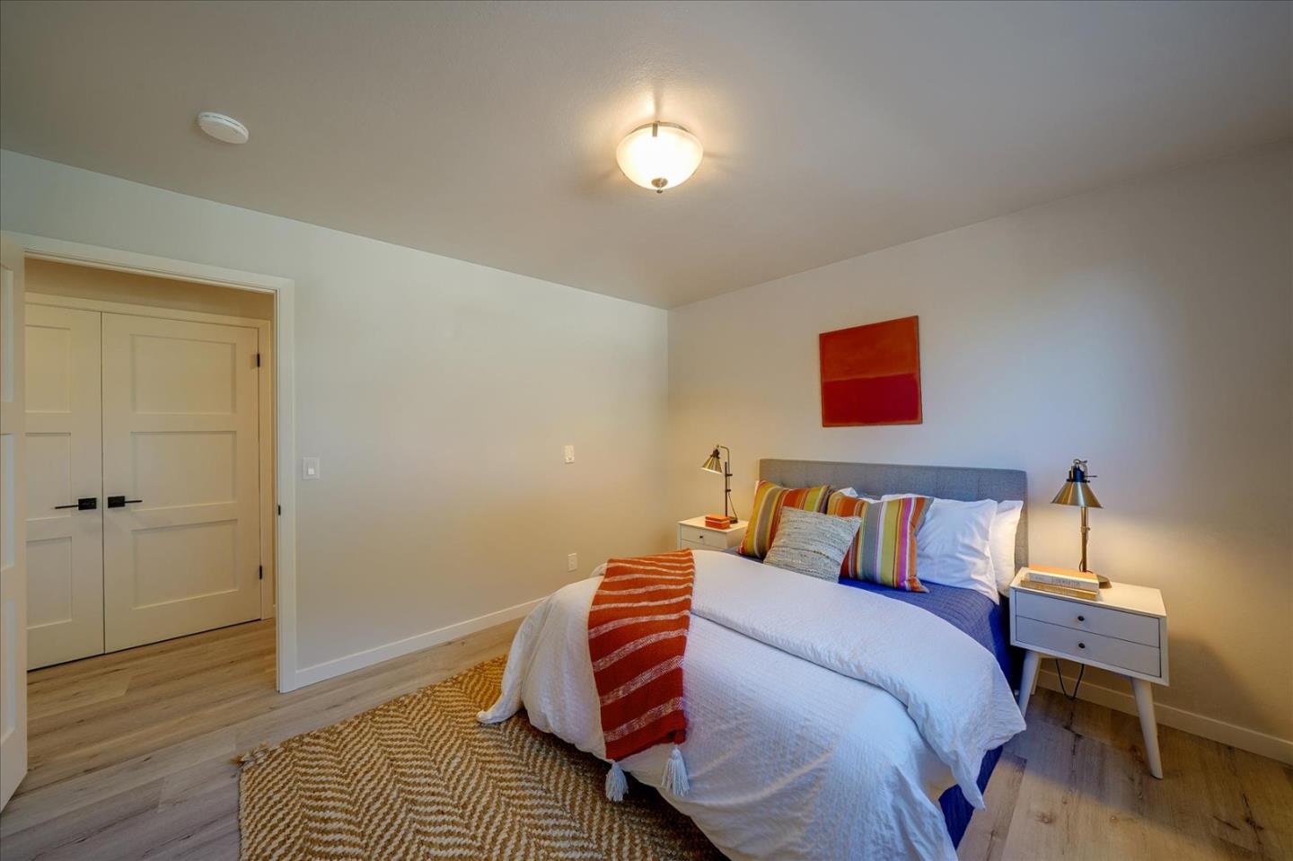 1122 Southdown Road Hillsborough, CA 94010 - Photo 21 of 42 a bedroom with a bed and a lamp with wooden floor