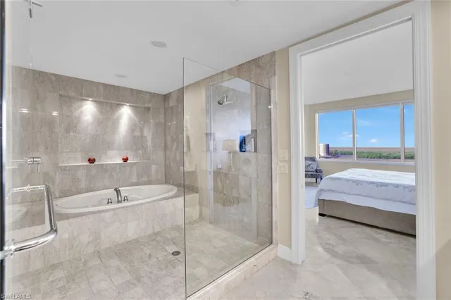 a spacious bathroom with a shower tub and a mirror