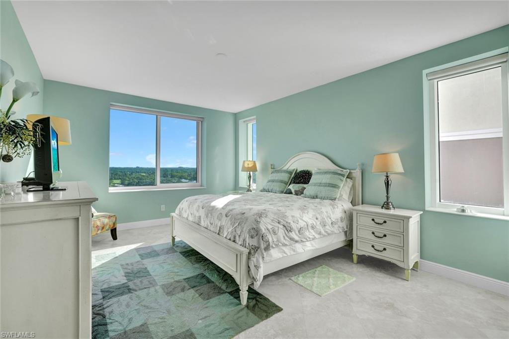 265 Indies Way, Unit 904 Naples, FL 34110 - Photo 13 of 19 a bedroom with a bed and a dresser