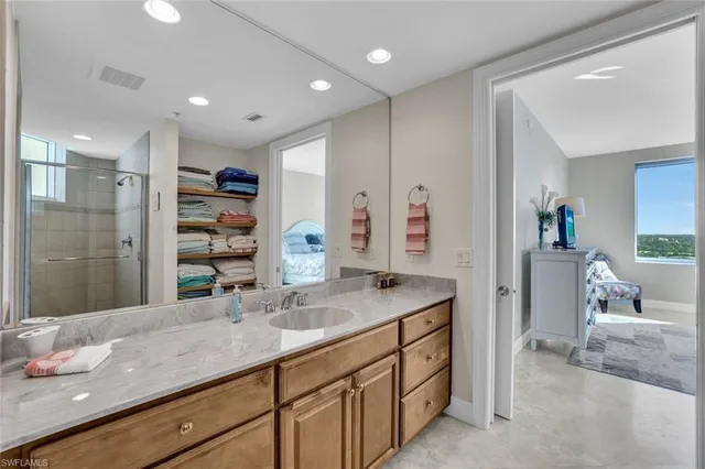 a bathroom with a granite countertop sink mirror and double