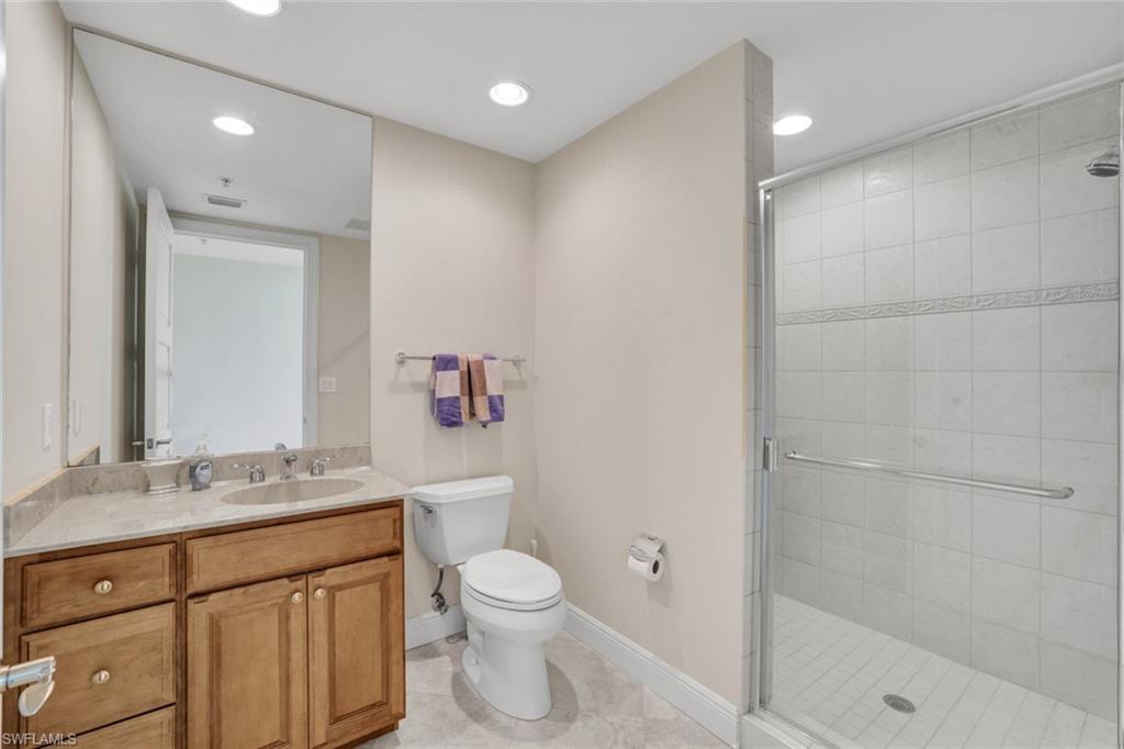 265 Indies Way, Unit 904 Naples, FL 34110 - Photo 16 of 19 a bathroom with a sink a toilet and shower