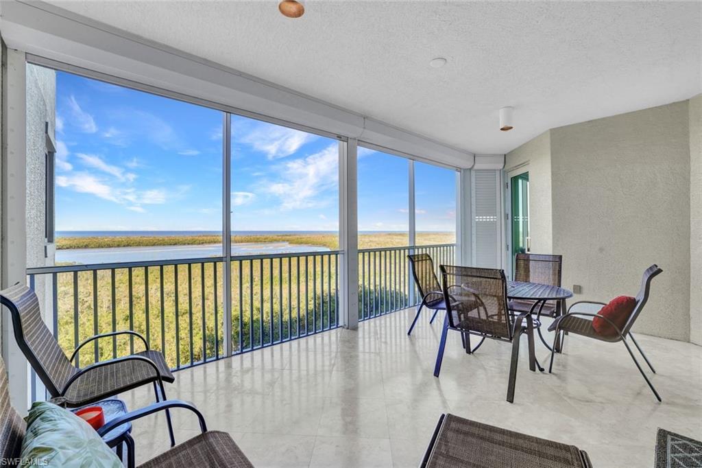 265 Indies Way, Unit 904 Naples, FL 34110 - Photo 17 of 19 a view of a dining room with furniture window and outside view