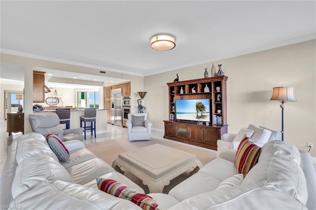 265 Indies Way, Unit 904 Naples, FL 34110 - Photo 3 of 19 a living room with furniture and a flat screen tv