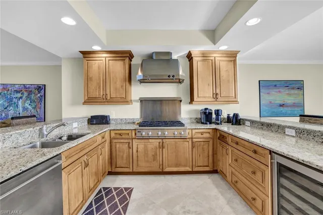 a kitchen with stainless steel appliances granite countertop a sink stove and cabinets
