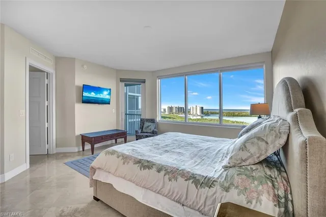 a bed room with a bed and a chair