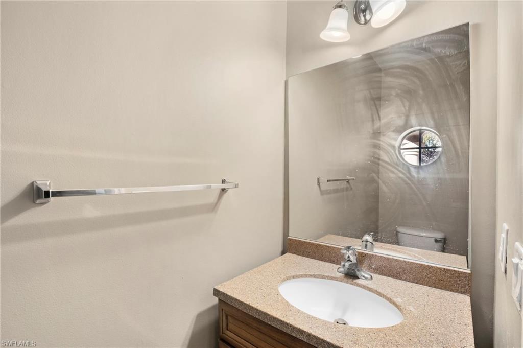 9648 Roundstone Circle Fort Myers, FL 33967 - Photo 13 of 30 a bathroom with a sink and mirror