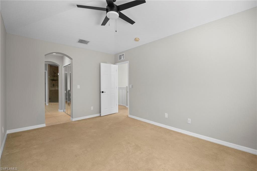 9648 Roundstone Circle Fort Myers, FL 33967 - Photo 16 of 30 en empty room with chandelier fan