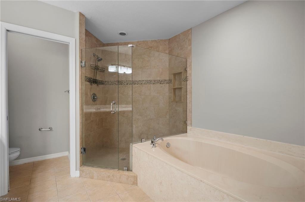 9648 Roundstone Circle Fort Myers, FL 33967 - Photo 20 of 30 a bathroom with a bathtub and shower