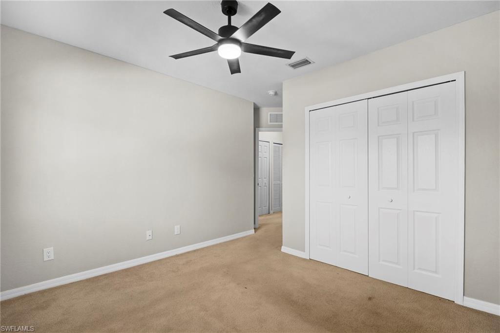 9648 Roundstone Circle Fort Myers, FL 33967 - Photo 22 of 30 an empty room with closet and fan