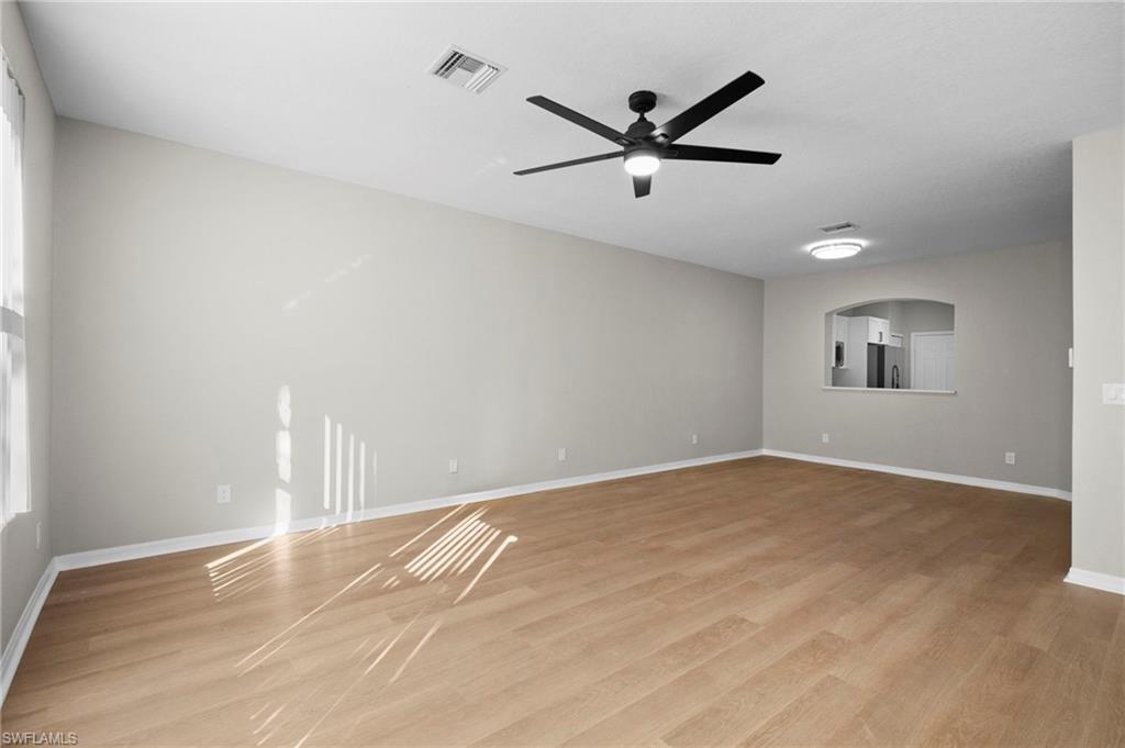 9648 Roundstone Circle Fort Myers, FL 33967 - Photo 5 of 30 a view of a big room with wooden floor closet and windows