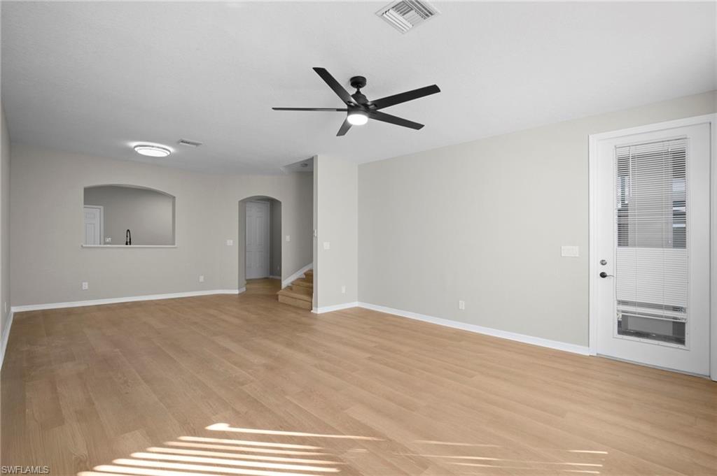 9648 Roundstone Circle Fort Myers, FL 33967 - Photo 6 of 30 a view of an empty room with window and a kitchen