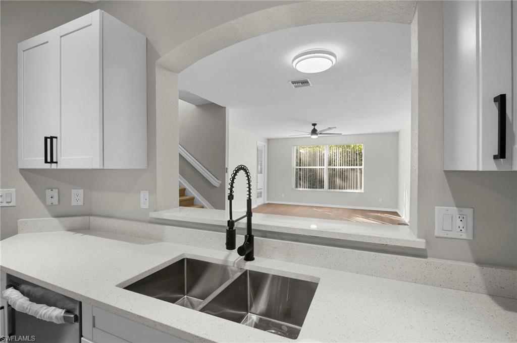 9648 Roundstone Circle Fort Myers, FL 33967 - Photo 10 of 30 a kitchen with a sink and a refrigerator