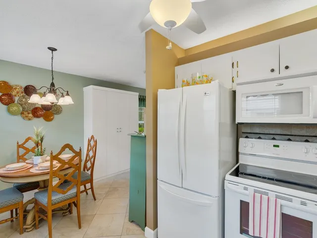 a kitchen with stainless steel appliances a stove a refrigerator and island