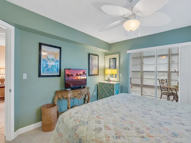 a bedroom with furniture and a flat screen tv