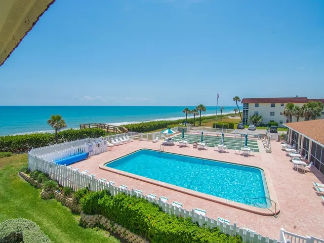 a view of a swimming pool with an outdoor seating